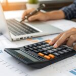 persona-calculando-finanzas-con-calculadora-y-graficos