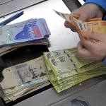 persona-contando-billetes-argentinos-en-banco