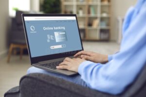 persona usando laptop con banca online abierta